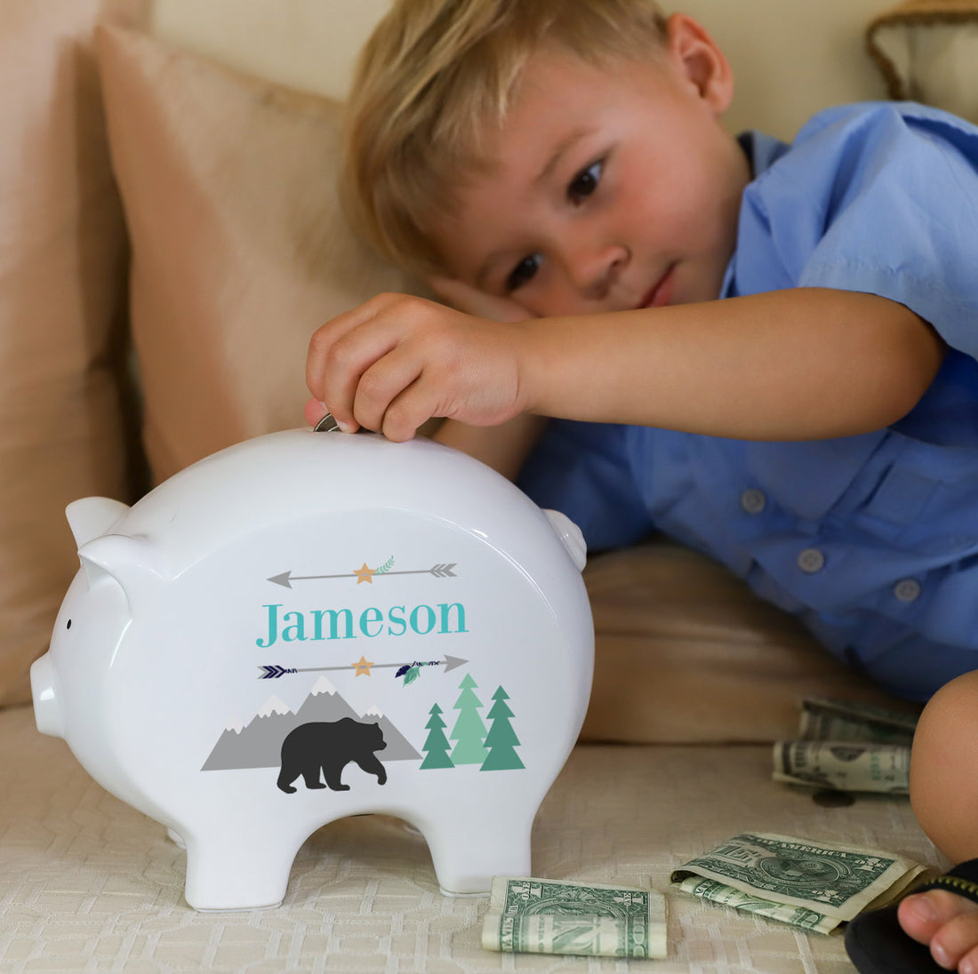 child putting coins into his own personalized piggy bankslider_item_Y4CxxE